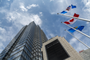 Worm's eye view of the EPCOR tower with flags